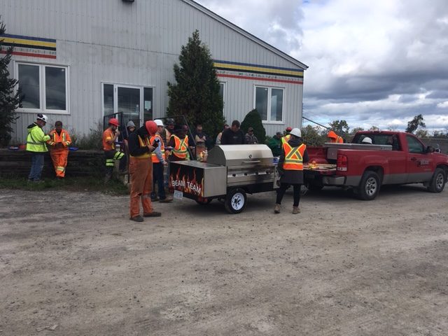 Beam Excavating team having a barbeque