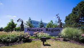 Photograph of large sign in front of a corporate glass building